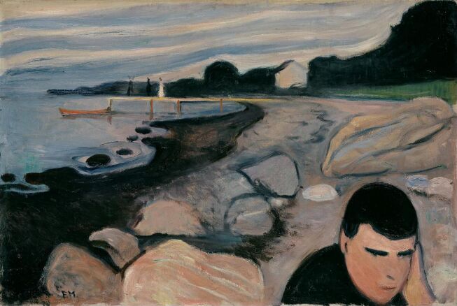 a man in the foreground of a beach, looking melancholy